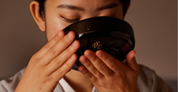 Japanische Teezeremonie - Frau trinkt Matcha Tee